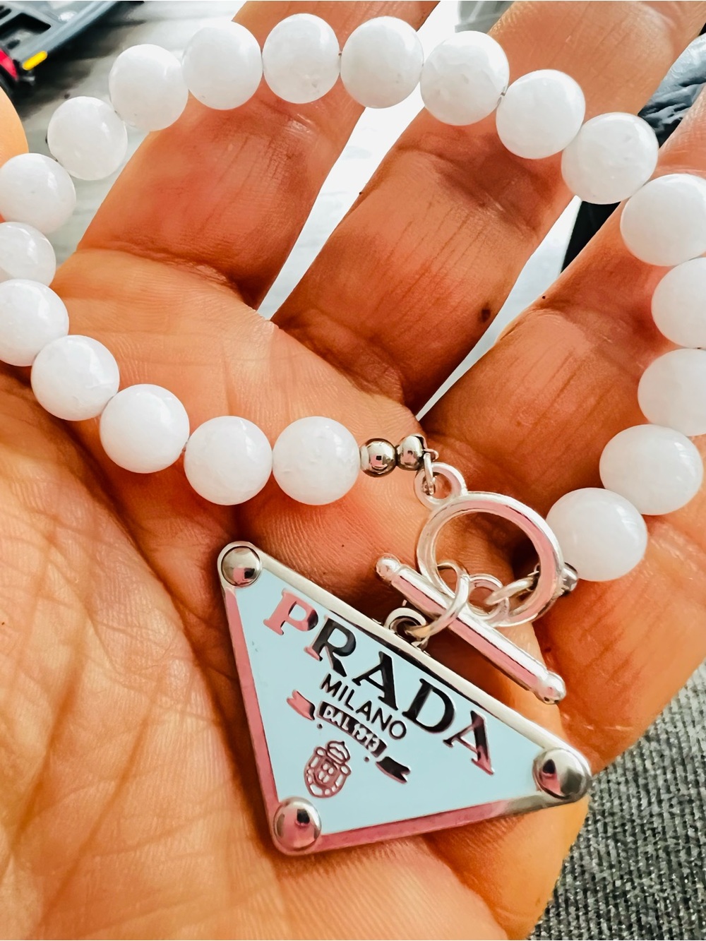 Fashion Unbranded White Beaded Bracelet with Silver Logo Triangle Charm